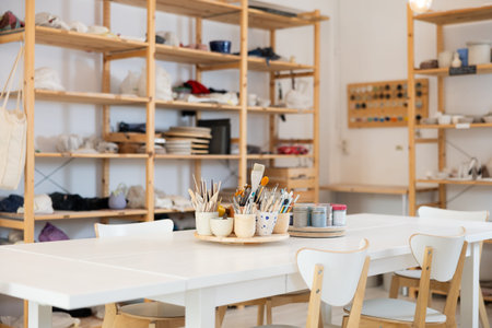 Pottery art studio with wooden shelves and table