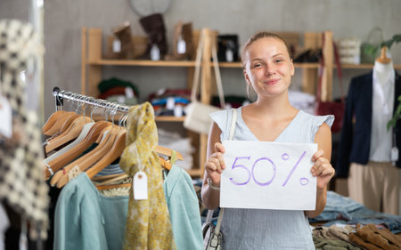 Woman with a sign 50 percentages discountの写真素材