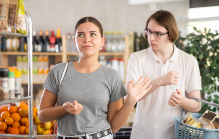 In shop guy stands behind wife.の写真素材