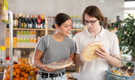 Couple young man and woman choosing pizzaの写真素材