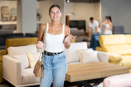 Young woman looking around in furniture storeの写真素材