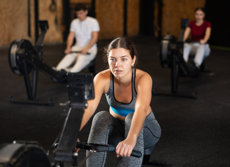 Woman in top exercising on rowing machine