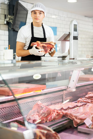 Guy seller works in specialized butcher shopの写真素材