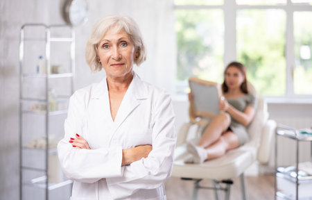 Portrait of elderly doctor in scrub.の写真素材