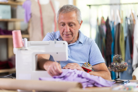 Senior man tailor at work