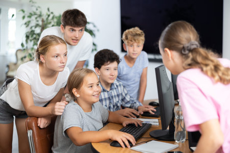 Group of students working at computer in classroom