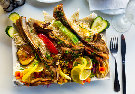 Lamb ribs with white rice, hummus and grilled vegetablesの写真素材