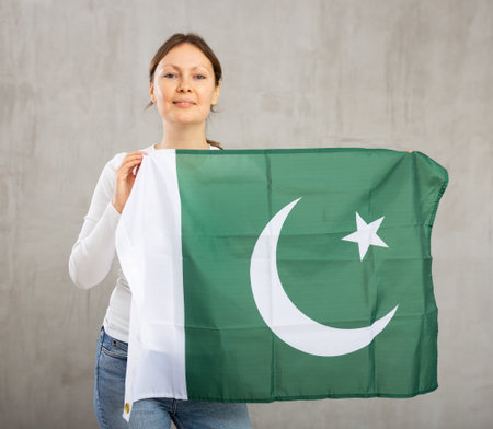 Happy smiling woman proudly displaying pakistani flagの写真素材
