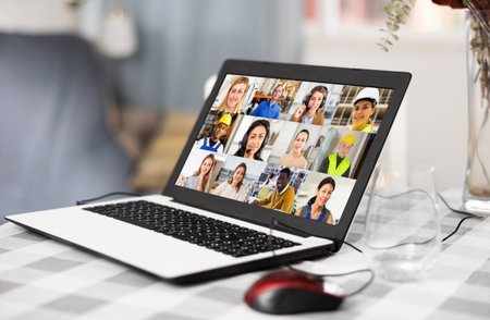 Image of a working laptop lying on a tableの写真素材