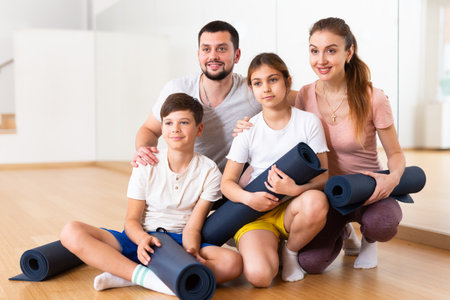 Portrait of happy family at yoga studioの写真素材