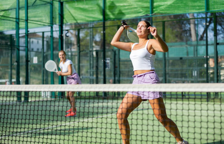 Woman padel tennis player training on courtの写真素材
