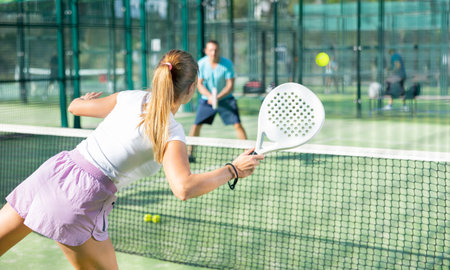 European woman tennis player in padel tennis playing on the outdoor courtの写真素材