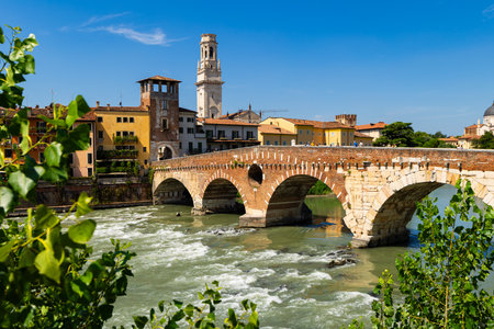 Arched ancient stone bridge over Adige River in city of Veniceのeditorial素材