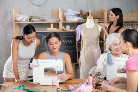 Group of women sew and work with mannequin at master class