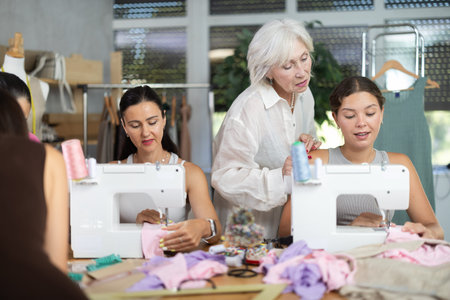 Sewing teacher guiding student during machine work