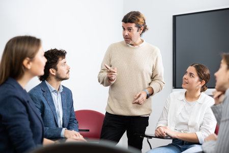 Knowledgeable professor explaining subject to classroom full of studentsのeditorial素材