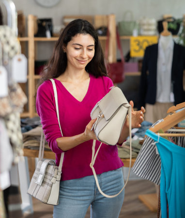 Armenian woman choosing a fashionable handbag