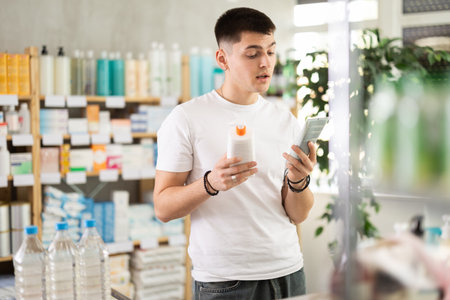 Guy buys emollient cream at pharmacyのeditorial素材