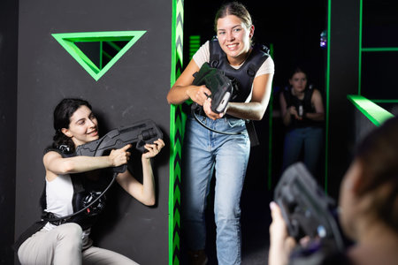 Girls play laser tag, jokingly fight with light weapons