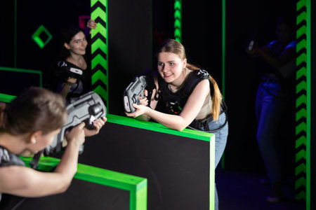 Girls play laser tag, jokingly fight with light weapons
