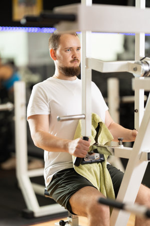 Man doing strength training on the simulator