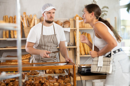 European woman visited bakery, communicates with male seller