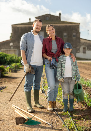 Man woman and boy near field harvest