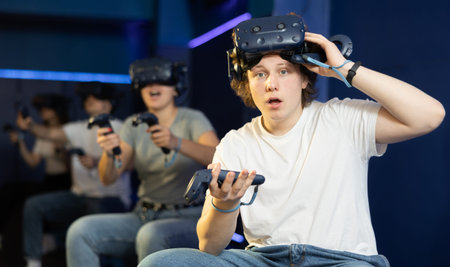 guy is exhilarated by turn of events in VR game and moved virtual reality glasses to forehead