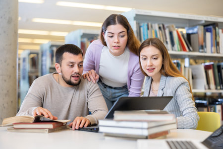 Students preparing for exam together, brainstorming in library