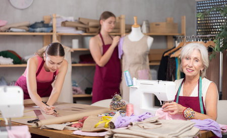 team of female seamstresses works in the atelier