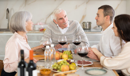 Happy senior man celebrating birthday with family