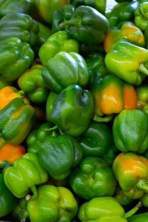 Many bell pepper on counter in grocery store close up