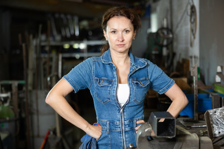 Adult woman posing in oak workshopの写真素材