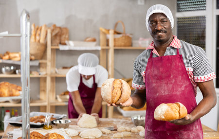 Adult man baker with homemade breadの写真素材