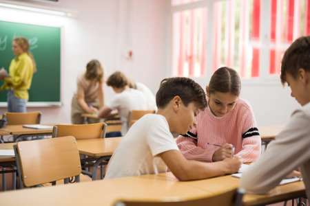 Schoolchilds working in groups at lesson