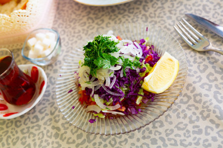 Turkish salad of red cabbage, tomatoes, cucumbers, onions, greens and lemon