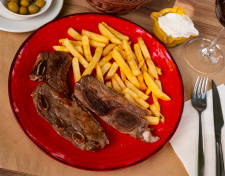 Meat served with potatoes on platterの写真素材