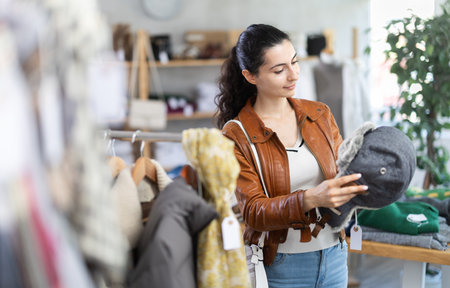 woman near showcase examine goods, fur hat.の写真素材