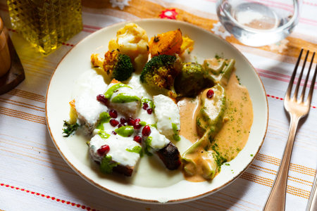 Cornbread slices with yogurt sauce and baked vegetablesの写真素材