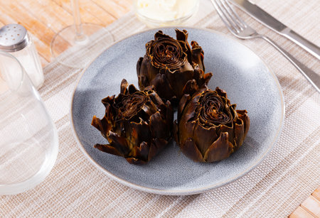 Just cooked artichokes served on plateの写真素材