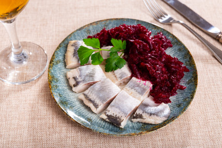 Nicely served sliced salted herring with beet salad on sideの写真素材