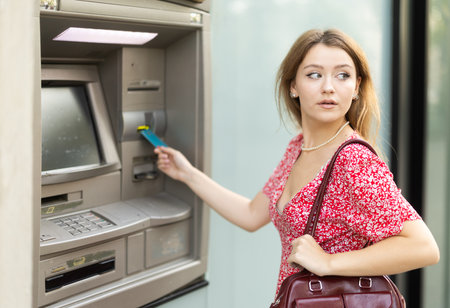 Young woman using card at atmの写真素材