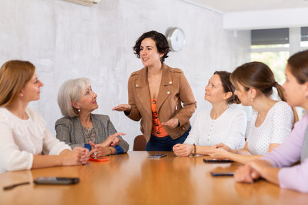 Female speaker giving presentation for cheerful positive smiling students in lecture hallの写真素材