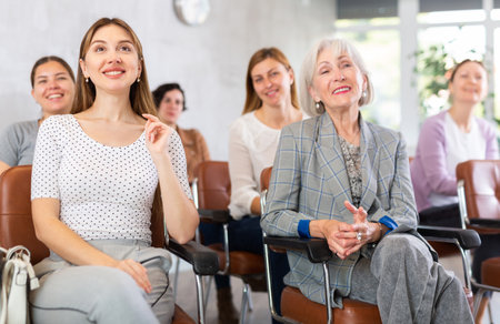 Female students listen to funny story of teacher during lecture at universityの写真素材