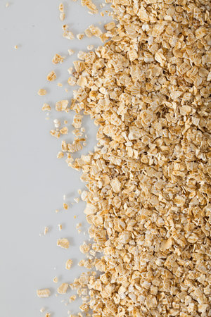 Dry oatmeal background on white surface , nobody