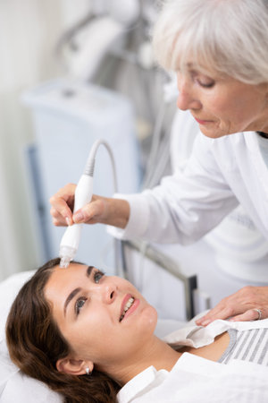 Young woman having face vacuum cleaning procedure