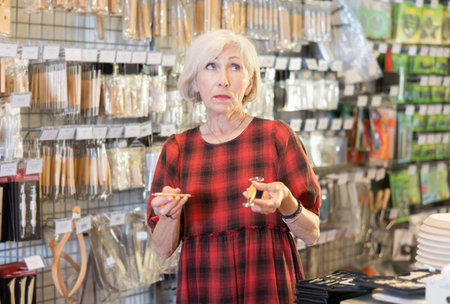 Elderly woman chooses tools for making sculpture