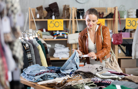 Woman choosing jeans in a storeの写真素材