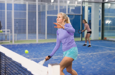 European woman playing padel