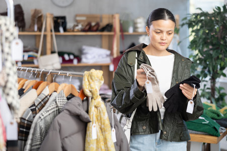 Asian woman browsing goods items and choose elect glovesの写真素材
